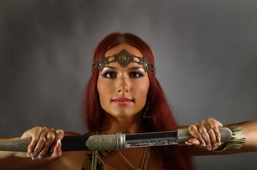 young warrior woman holding sword in her hand