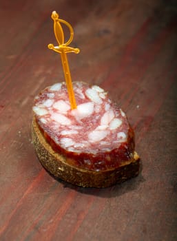 Canape with salami . Shallow depth-of-field. 