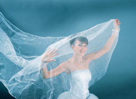 Beauty young bride dressed in elegance white wedding dress  gray studio background 