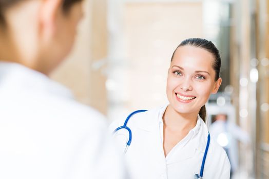 two doctors talking in the lobby of the hospital,