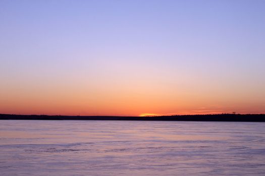 sunset over frozen river