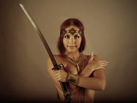 young warrior woman holding sword in her hand