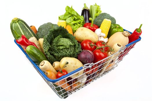 A shopping basket full of Vegetables on a white background.