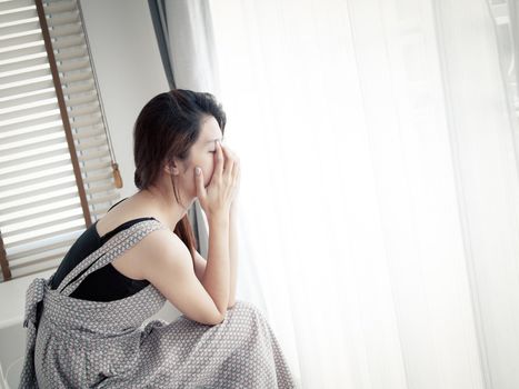 sad woman sitting alone in room