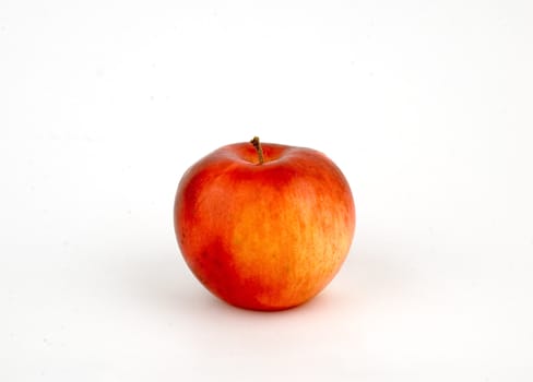 General view of an apple red and yellow on a white background