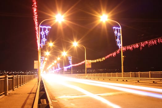 light tracks of cars on bridge at night