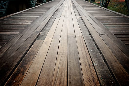 Old wooden road on the metal bridge