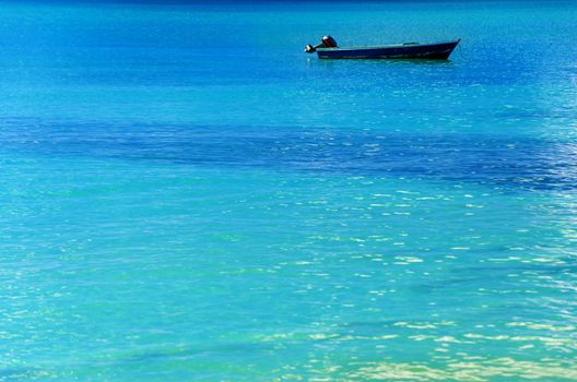 Blue boat in turquoise Caribbean water in San Andres y Providencia, Colombia