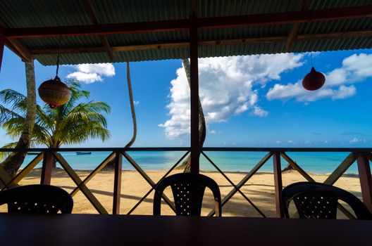 View of white sand beach from inside restaurant in San Andres y Providencia, Colombia