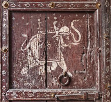 Old wooden door with a picture of an elephant. Fragment. Rajasthan, India