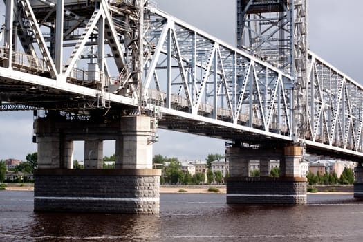 A big metal modern bridge on a river
