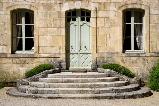 Vintage house wall with entrance staircase, door and windows