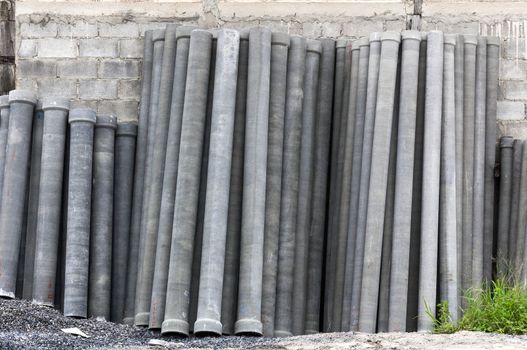 Stack of many concrete drainage pipe on wall  in construction site