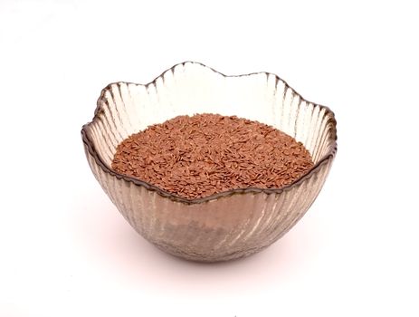 General view of the flax seeds in a glass vase on a translucent white