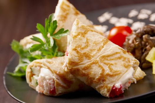 rolled pancakes stuffed . Shallow depth-of-field.
