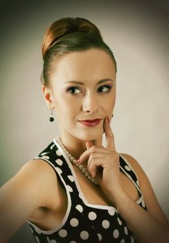 Girl in american 60s style in  polka dot dress 