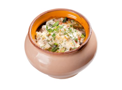 Roasted slices of potato in rustic clay pot