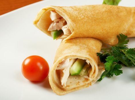 rolled pancakes stuffed chicken. Shallow depth-of-field.