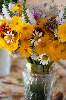 Beautiful bouquet of wild flowers in a purple bucket