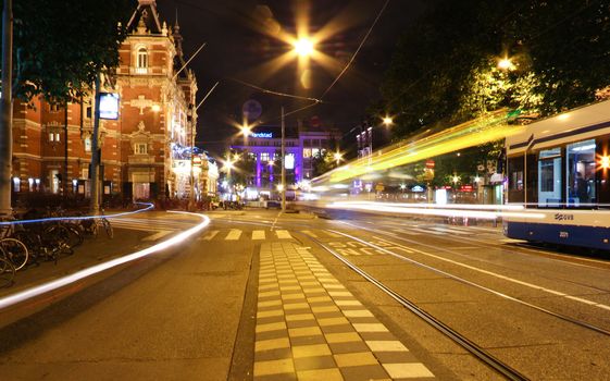 Tram stopped in Leidseplein plaza at night in Amsterdam.