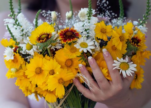 Arm with yellow wild flowers