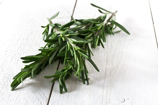 Fresh rosemary on white wooden table