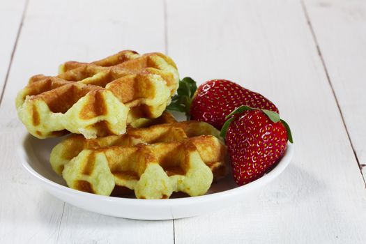 Freshly baked waffles with strawberries