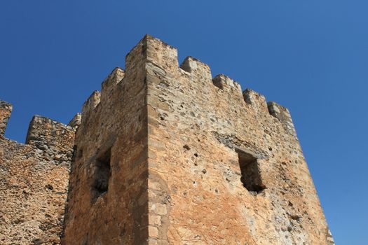 Old stone fortress castle tower blue sky background