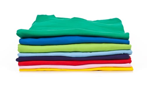 a stack of colorful t shirts, shot in studio