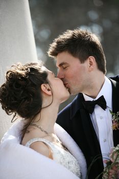 The groom and the bride kiss