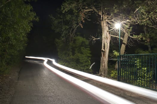 traces of headlights on night road