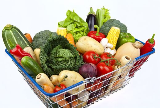 A shopping basket full of Vegetables on a white background.