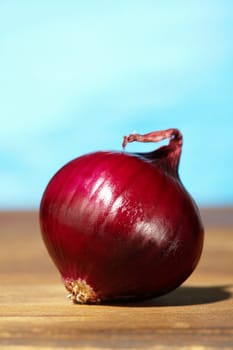 Red  onion on wooden background