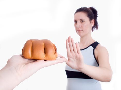 Woman refuses muffins isolated on white background