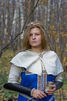 Portrait of the romantic girl in autumn forest