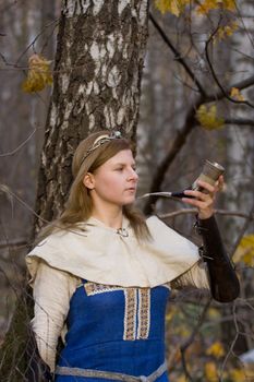 Portrait of the romantic girl in autumn forest