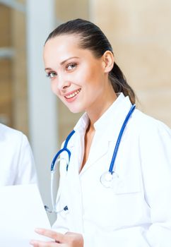 close-up portrait of a woman doctor in a medical gown