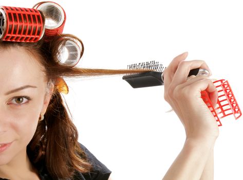 Young Attractive Woman Using Curlers with Hairbrush closeup on white background