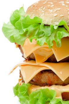 Big Tasty Double Hamburger with Beef, Cheese, Tomato and Lettuce on Sesame Seed Bun closeup isolated on white background