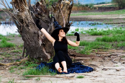 Halloween witch stretching after a nap, having decided to new adventures