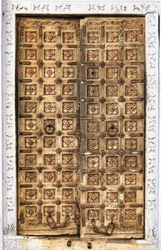 Old wooden door with floral decoration. Rajasthan,India