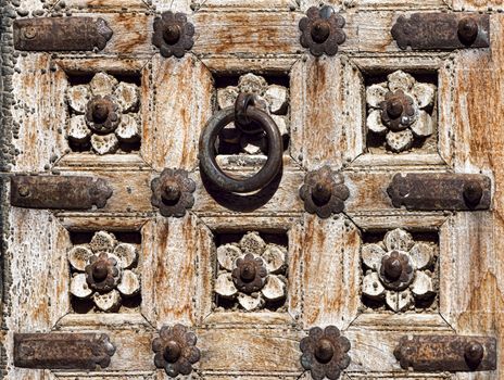 Old wooden door with floral decoration. Fragment. Rajasthan,India