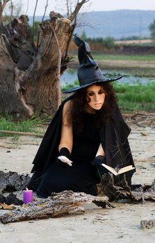 Witch conjures spells vychityvaya pronouncing them in a book