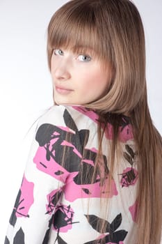 Young beautiful blond Caucasian girl on white background.