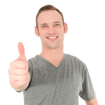 Handsome smiling charming young man giving a thumbs up gesture of approval and success isolated on white