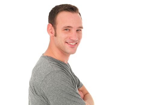 Young caucasian man smiling sideways at the camera.