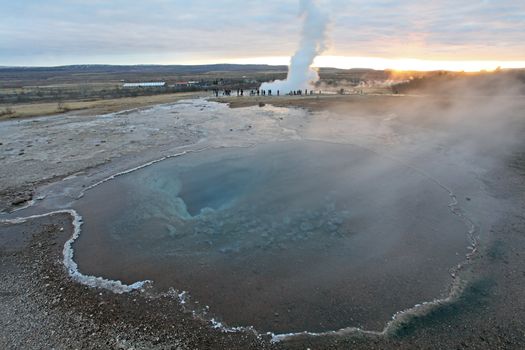 Strokkur Geyser and hot spring in Iceland erupting at sunset in winter