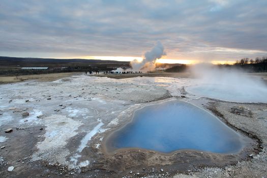 Strokkur Geyser and hot spring in Iceland erupting at sunset in winter