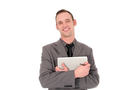 Handsome friendly businessman clasping a tablet to his chest smiling cheerfully at the camera isolated on white