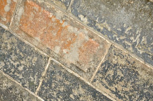 Close up of gray and rust colored block wall